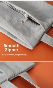 Detail of gray waterproof travel organizer bag showing smooth zipper and reinforced handle