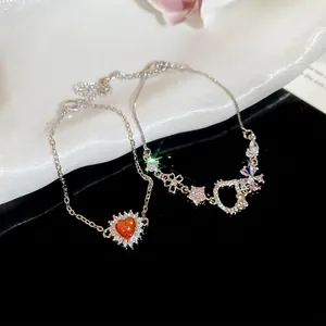 Elegant silver bracelets featuring zircon heart pendant and D-letter charm motifs