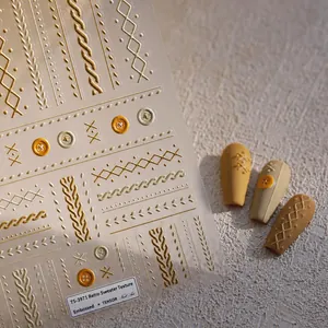 Macro detail of gold embossed nail stickers with vintage sweater knit patterns and textures