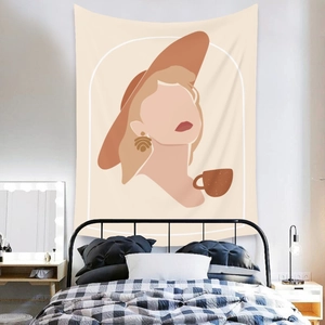 Detail of bohemian tapestry featuring a minimalist female portrait over a cozy bed
