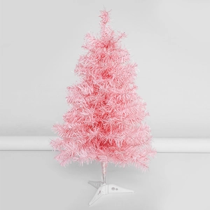Pink artificial PVC pine needle Christmas tree with white stand on a clean gray background