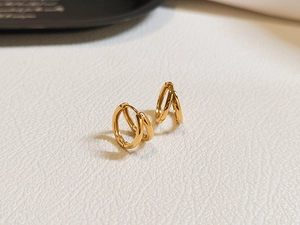 Macro detail of French minimalist S925 silver double hoop earrings in golden finish