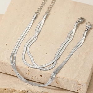Close-up of double-layer silver snake chain necklace with lobster clasp and extension