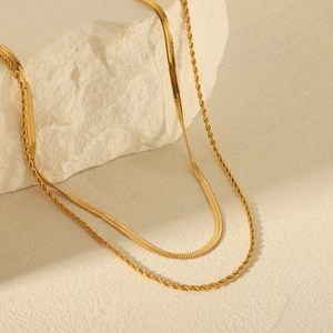 Double-layered gold stainless steel necklace featuring a snake chain and a twisted rope chain