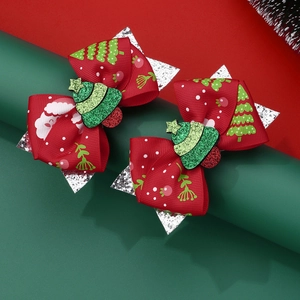 Handmade Christmas bow hair clips with festive Santa Claus and tree patterns for girls