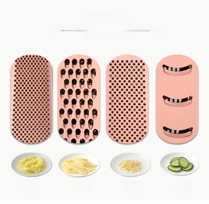 Detailed view of four pink interchangeable stainless steel slicer blades for kitchen use
