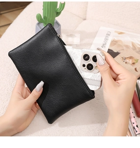 Close-up of black lychee texture PU leather pouch with silver zipper for smartphones