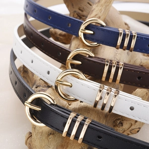 Set of four minimalist faux leather belts in blue, brown, white and black with gold buckles