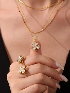 Detail view of 18k gold-plated flower jewelry set featuring shimmering 5A zircon stones