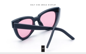 Detail view of pink lens cat eye sunglasses with 180 degree flexible hinge display