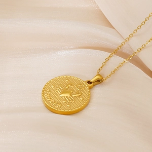 Macro detail of 18K gold plated Cancer zodiac pendant with crab relief and coin edge