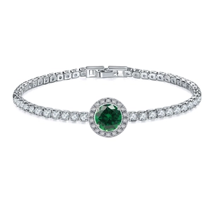 Close-up of a silver-toned tennis bracelet featuring a green halo gemstone and zircon accents