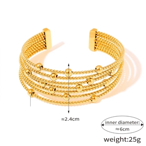 Detail view of gold titanium steel multi-layer twisted cuff bracelet with beads