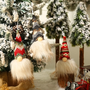 Lighted Christmas gnomes with white beards and knit hats on snowy tree branches