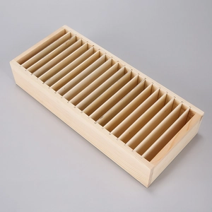 Detail of wooden organizer box with multiple vertical slots for cards and jewelry