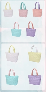 Detail showing various colors of heart quilted tote bags with premium soft texture
