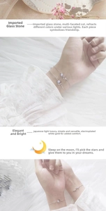 Detail of faceted glass moon and star bracelets with platinum plated finish and lace