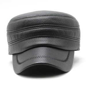 Close-up of black leather flat top cap featuring detailed Z-shape stitching and texture