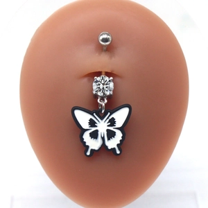 Detail of butterfly navel ring with white zircon on professional belly model