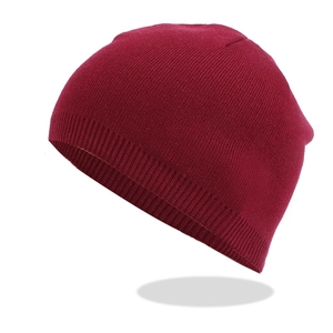 Close-up of dark red winter beanie showing detailed ribbed knit texture and soft fabric