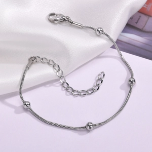Detail of silver snake chain bracelet with solid beads and adjustable lobster clasp