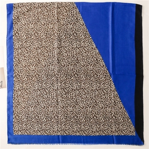Detailed texture of cotton linen scarf featuring leopard print and royal blue contrast