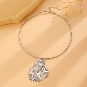 Detail shot of silver choker necklace featuring a double leaf pendant with wrinkled texture