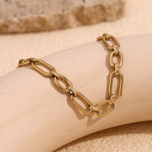 Detail of 14K gold-plated stainless steel paperclip chain anklet with polished texture