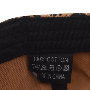 Close-up of leopard print baseball cap inner lining and 100% cotton material label