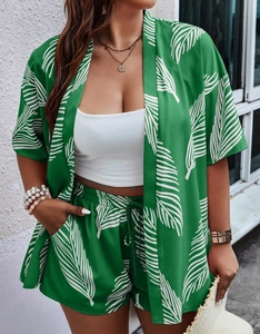 Detail of green and white tropical leaf print on summer kimono cardigan and shorts set