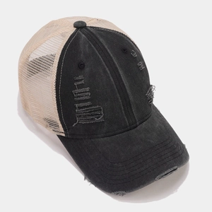 Distressed black cotton trucker hat with torn details and beige breathable mesh back