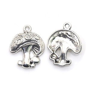 Antique silver mushroom charms for DIY jewelry making in a flat lay vintage style