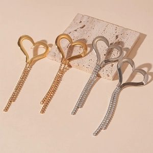 Elegant oversized heart earrings with long rhinestone tassels in gold and silver
