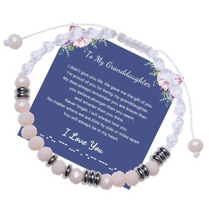 Detail of hand-woven beaded Morse code bracelet on a blue gift card for granddaughters