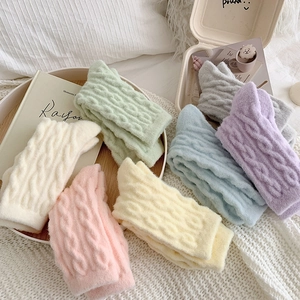 Detail view of cozy women fleece lined thick wool socks in pastel cream colors for winter warmth.