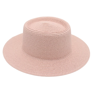 Detail of pink woven straw boater hat with fine texture and classic round crown