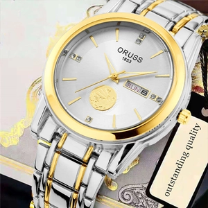 Detail shot of men's quartz watch dial with date display and gold embossed logo