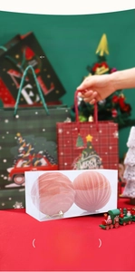 Detailed view of pink flocked Christmas balls with stripe texture in festive gift packaging