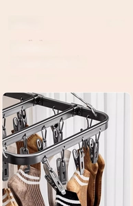 Detail of black aluminum drying rack showing strong metal clips for hanging socks
