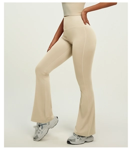 Detail view of high waisted flared yoga pants in light beige with smooth seam stitching