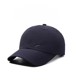 Close-up of navy blue quick-dry baseball cap with brand logo and breathable fabric