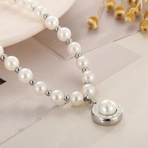 Elegant French pearl necklace with rhinestone circular pendant on a soft beige backdrop