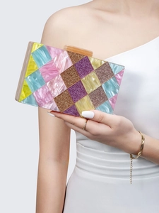 Close-up of colorful patchwork acrylic clutch bag with pearlescent pink and blue panels