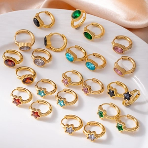 Gold stainless steel hoop earrings with colorful emerald and star zircon on silk background
