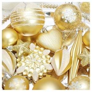 Detailed view of assorted gold and white Christmas ornaments with glitter snowflake patterns