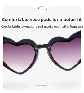 Detail view of the heart-shaped sunglasses with purple gradient lenses and comfortable nose pads