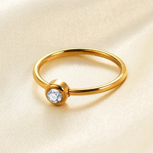 Close-up of a 2mm 18K gold plated stainless steel ring with a round zircon stone
