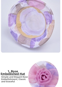 Detail of lavender sun hat showing mesh embroidery and a large chiffon rose decoration