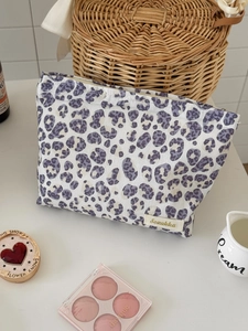Purple leopard print canvas makeup bag with zipper closure and Suzakka brand label