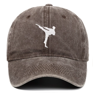 Detail of white kung fu embroidery on brown washed cotton vintage baseball cap